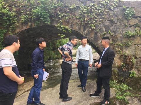 A group of people standing on top of a mountainDescription automatically generated