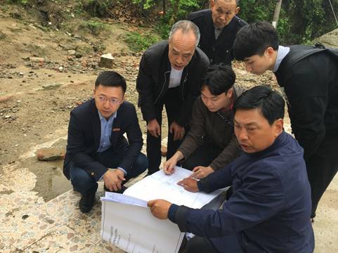 A group of people sitting on a benchDescription automatically generated